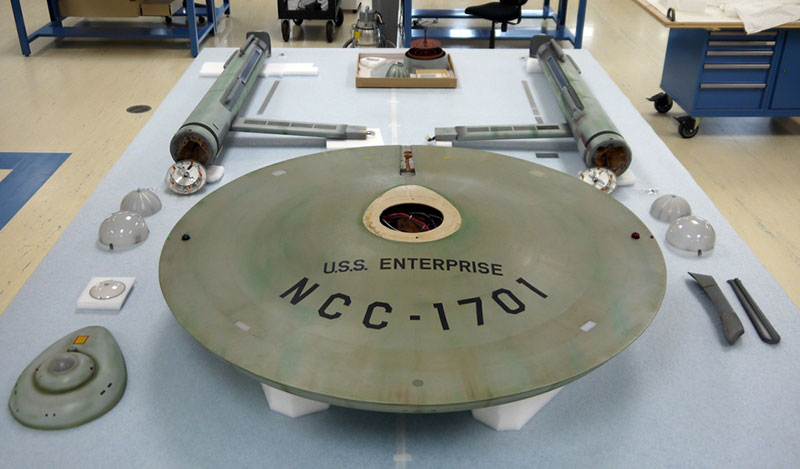 The Star Trek starship Enterprise model seperated into its component parts. As part of the conservation of the model, each original section will be studied to determine its construction and condition and will be documented with visible, ultraviolet, and infrared photography. 