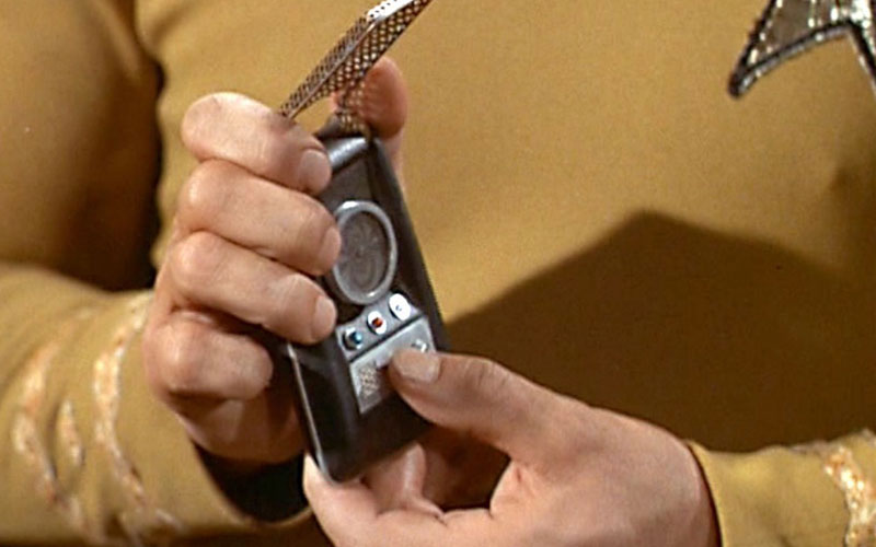 Captain Kirk holding a communicator on The Original Series